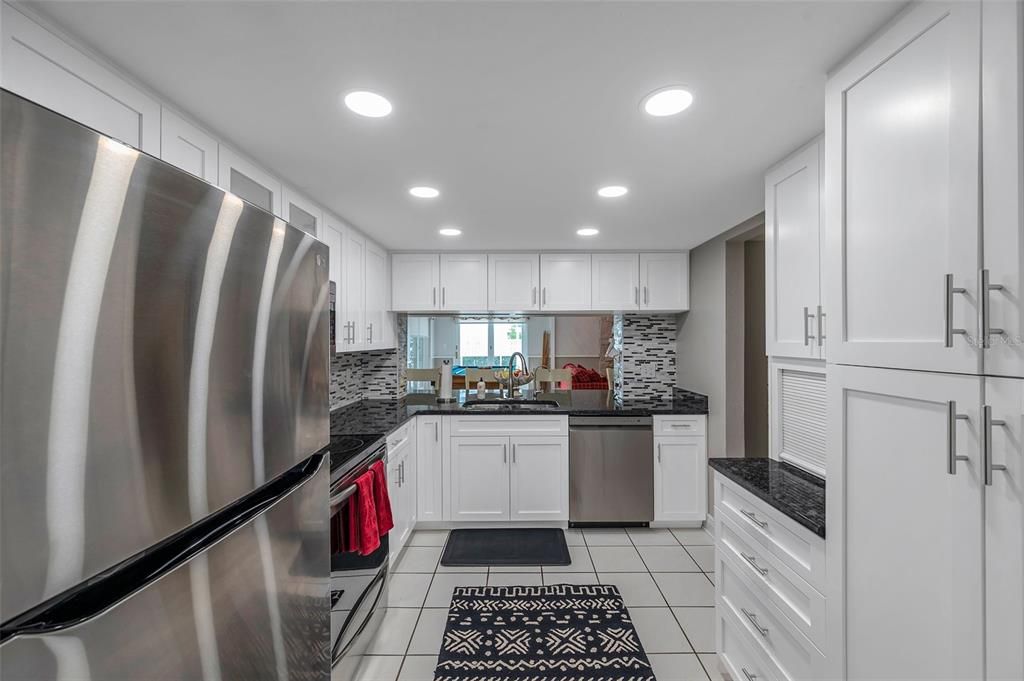 Kitchen showing large pass-thru to family area.