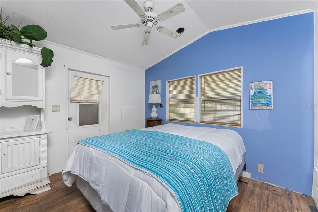 Bedroom has a cathedral ceiling and ceiling fan