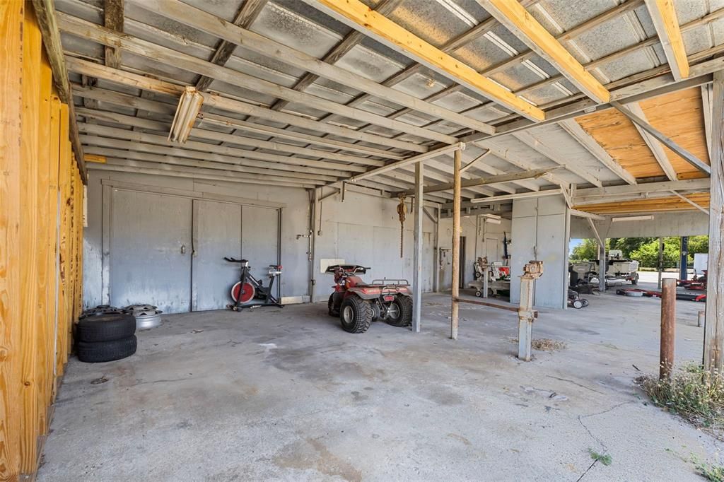 ONE OF SEVERAL CARPORTS IN BACK OF OUTBUILDINGS