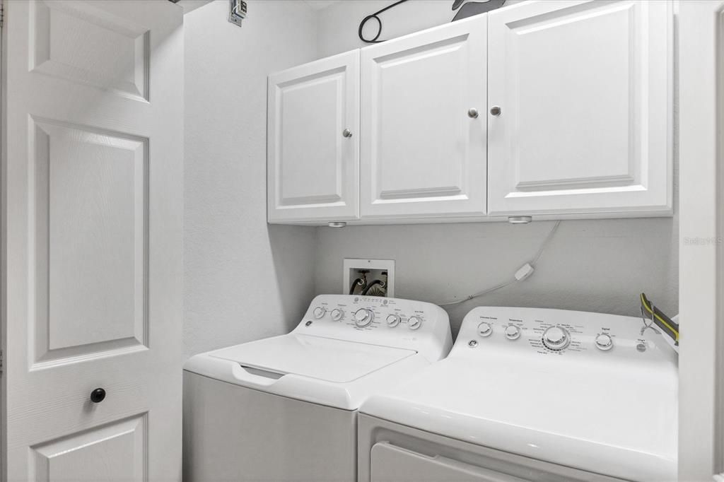 Laundry with cabinets for storage