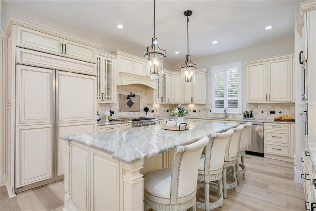 Beautifully master designed kitchen with quartz countertops, elegant 42' solid wood cabinets, and designer light fixtures.