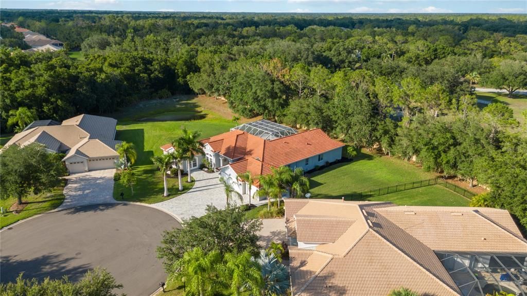 Home is surrounded by mature lush tropical Florida landscaping creating a relaxing sanctuary.