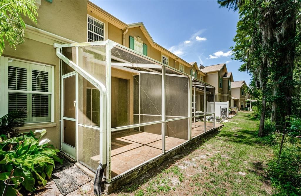 Screen enclosed back porch with privacy and preserve