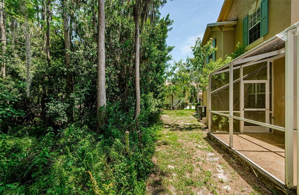 Screen enclosed back porch with privacy and preserve