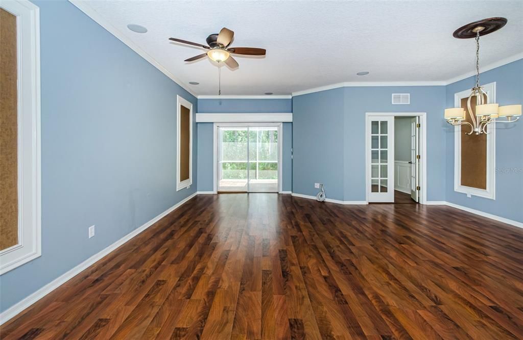 Living and dining space that is open to kitchen and glass sliders