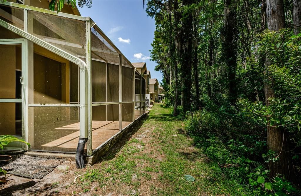 Screen enclosed back porch with privacy and preserve