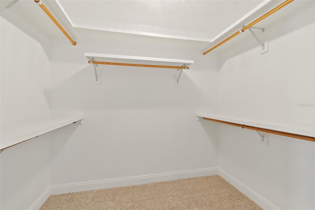 CLOSETS HAVE WOODEN POSTS & SHELVING FOR CLOTHES