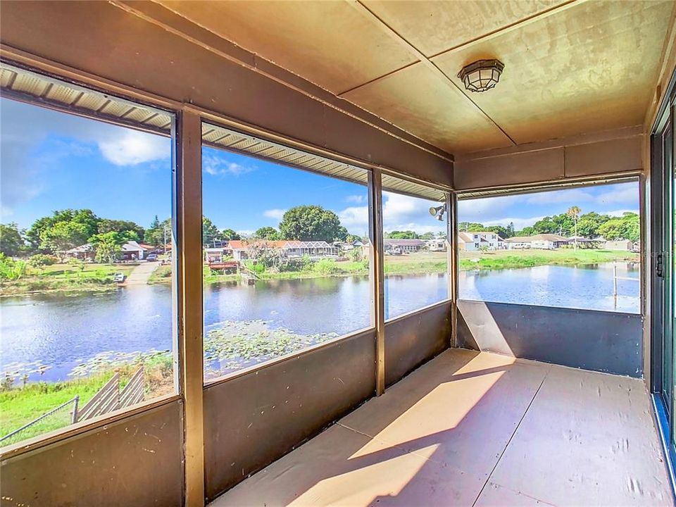 Screened porch with waterfront view.