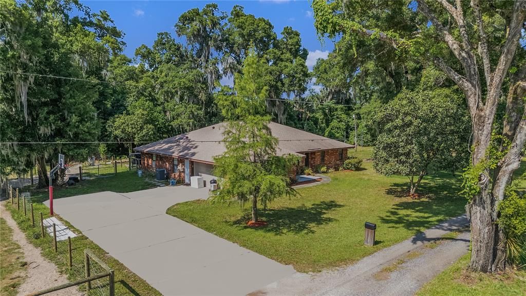 driveway to home with basketball court