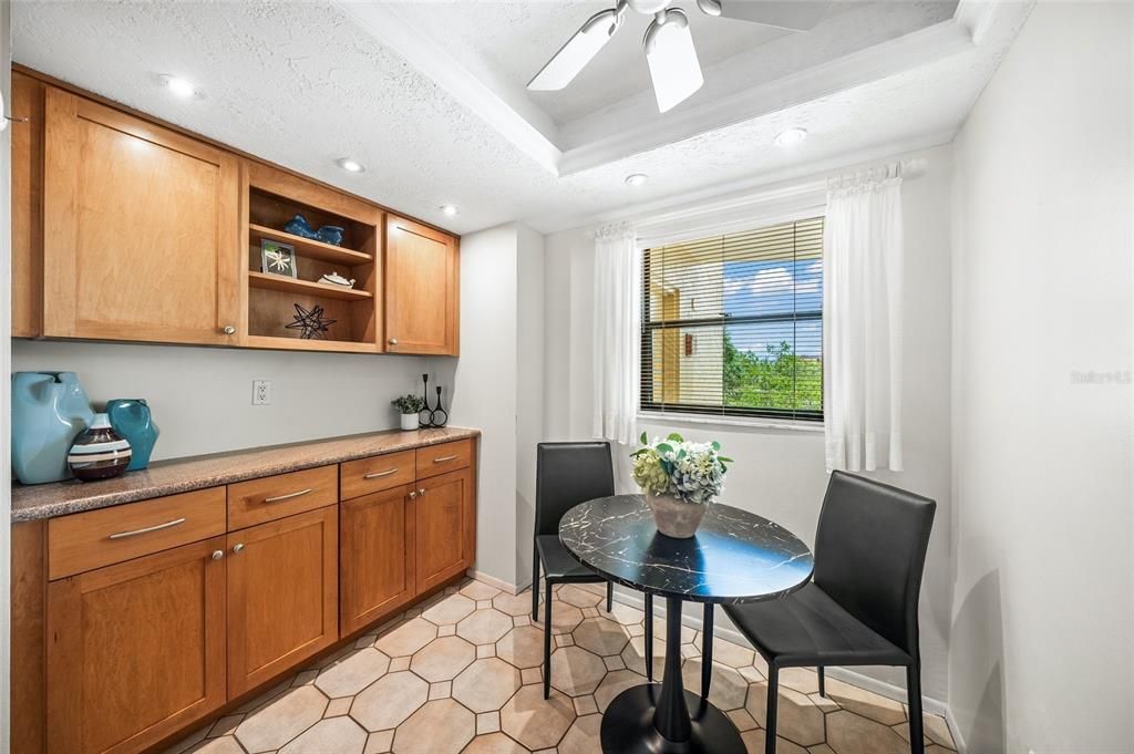 Kitchen eat in area with extra cabinets for storage.