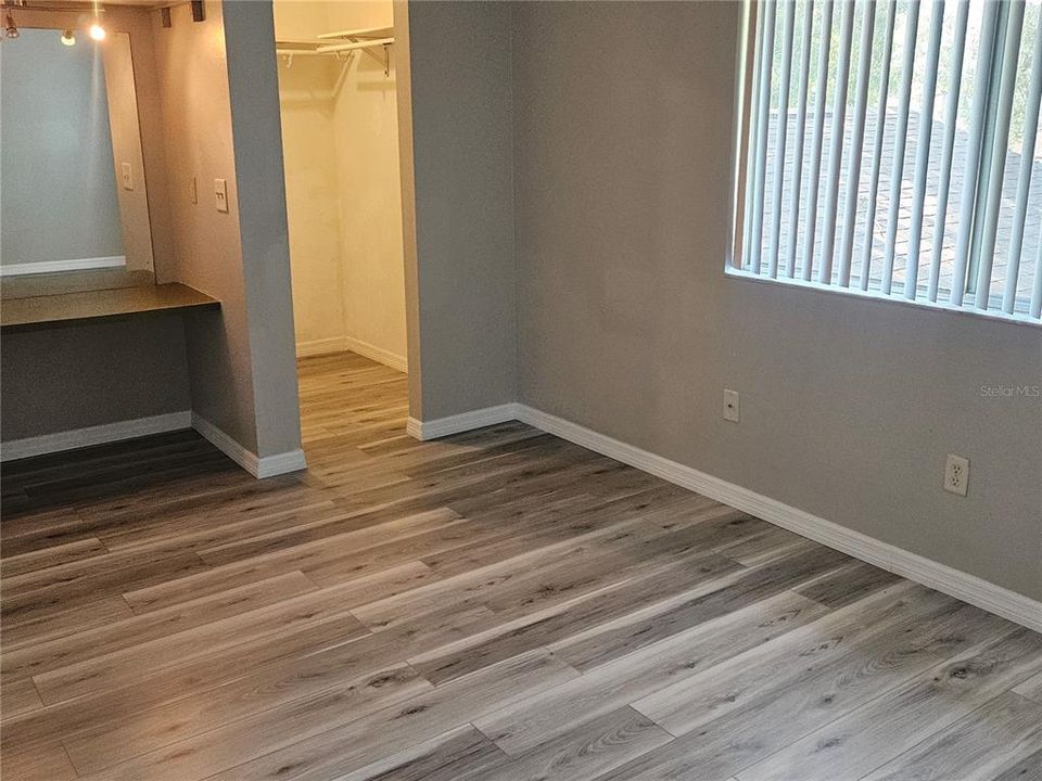 Primary with makeup area and walk in closet.