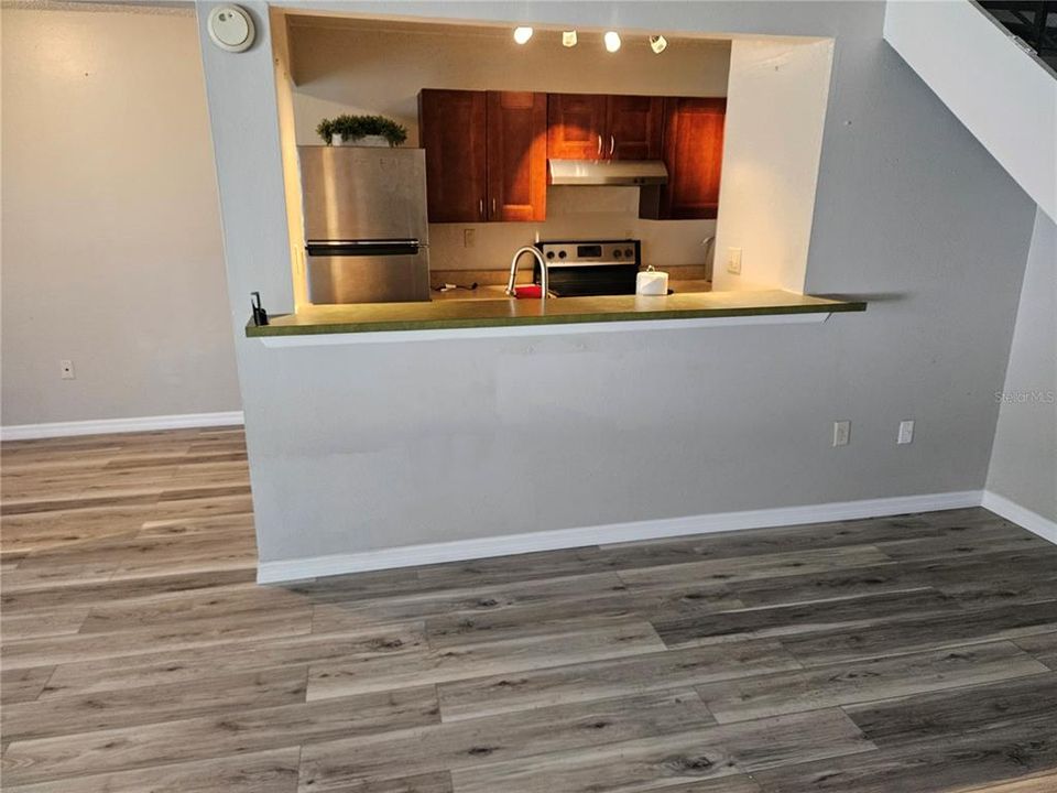 Kitchen has bar opening into Living Room.