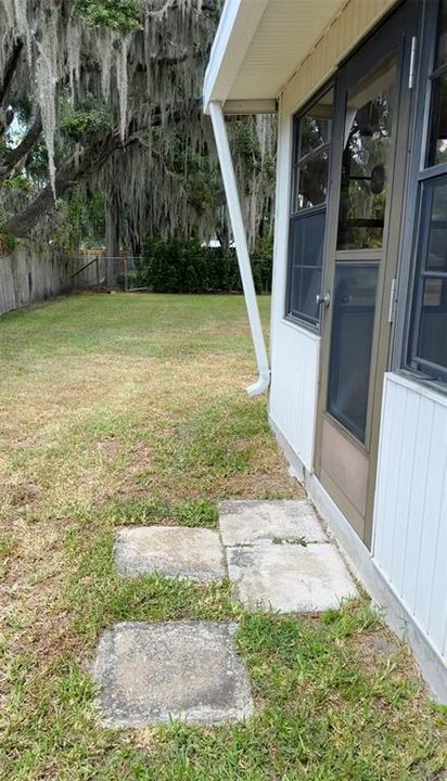 Exit door from Florida room with gutters into the side yard