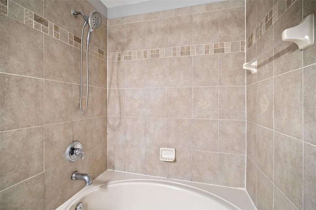 Deep soaking tub and shower combo in en suite bathroom