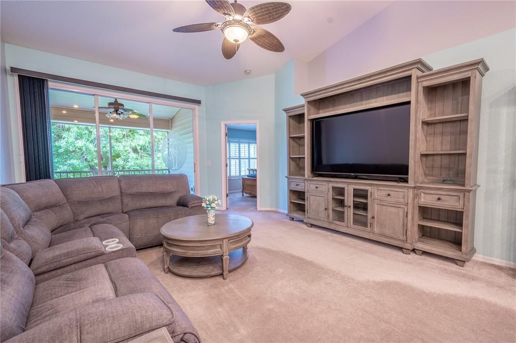 Plush carpet and soft hues make the living room a comfortable sanctuary.