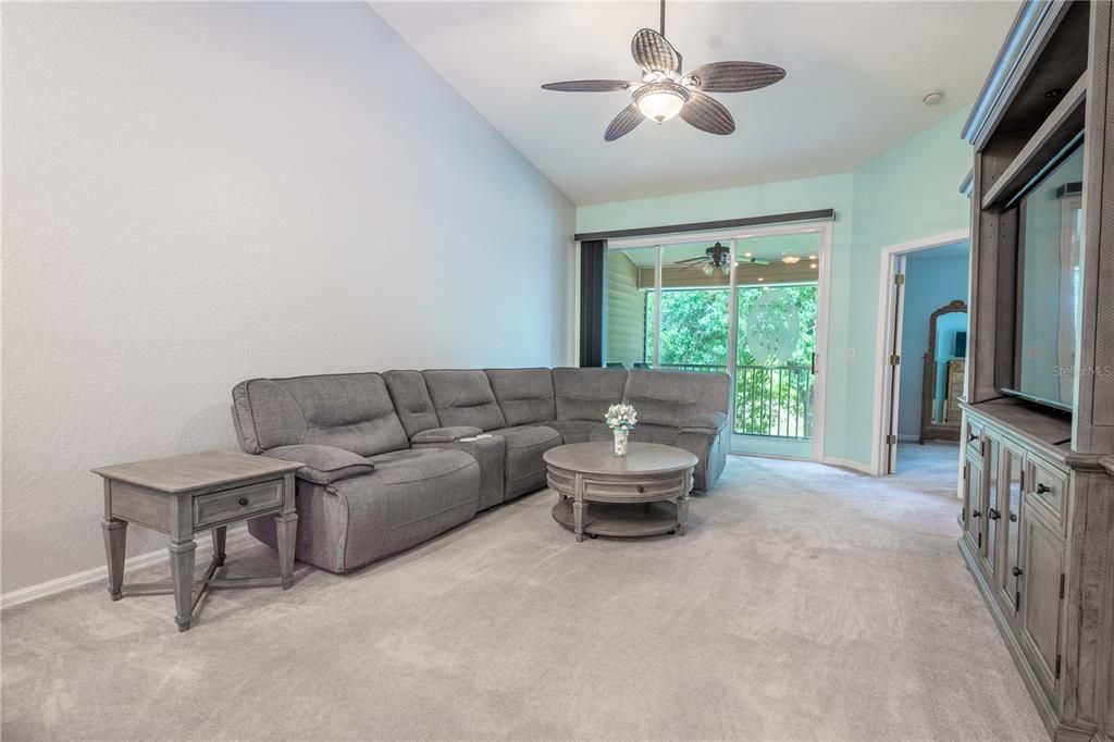 The living room features sliding glass doors to the balcony with waterview.