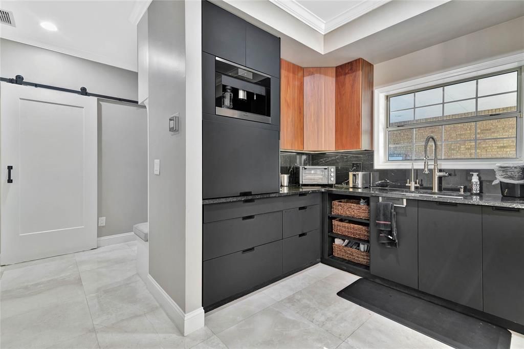 Builtin Miele Coffee Maker and prep area in kitchen