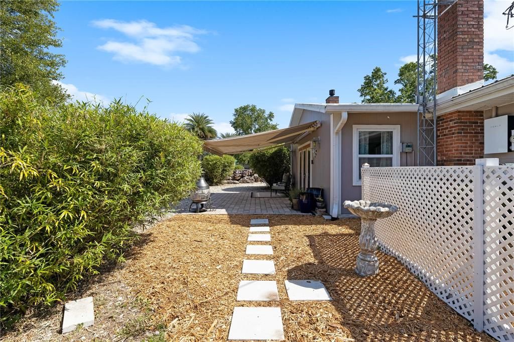 Rear patio with remote controlled Sunbrella awning