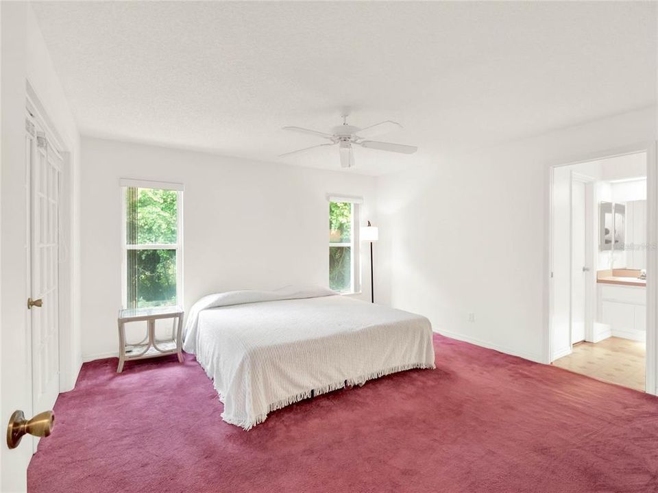 Primary bedroom located at the rear of the home. With French doors that open to the Sunroom. Double (His & Her) walk-in closets and an ensuite bath featuring jetted garden tub and separate shower.