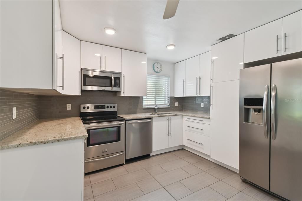 Updated kitchen has granite counters and stainless appliances