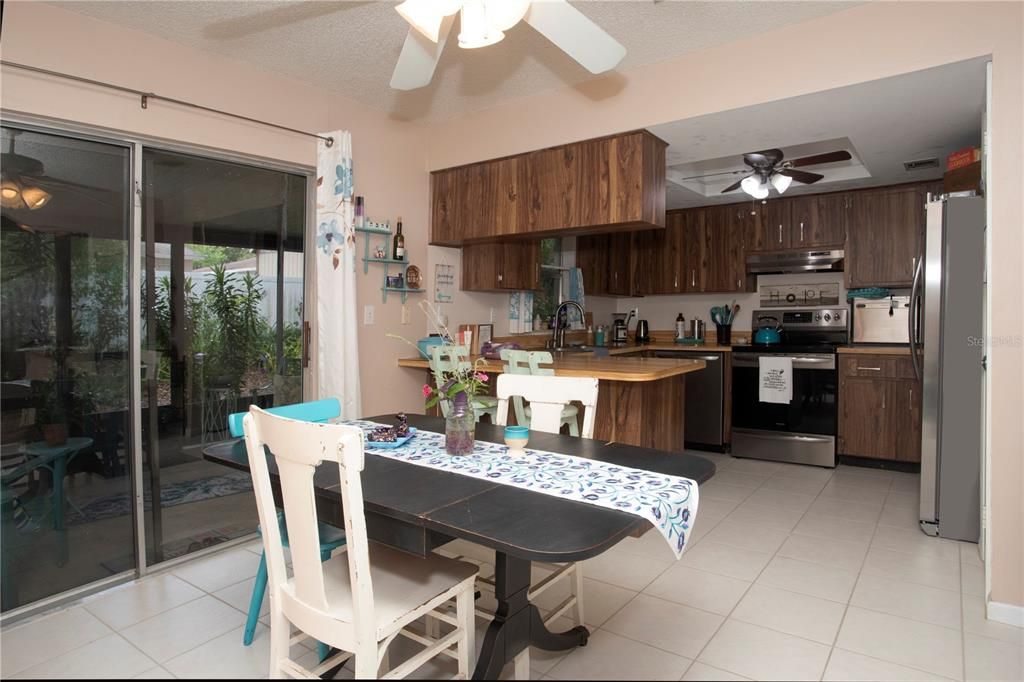 KITCHEN/DINING ROOM WITH SLIDER TO SCREENED AND COVERED BACK PORCH