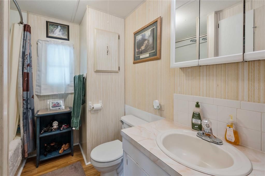 Guest bath has tub/shower combo.