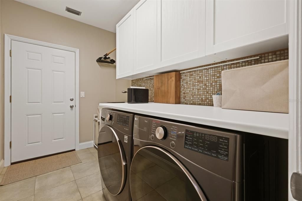 interior laundry room with utility sink and storage