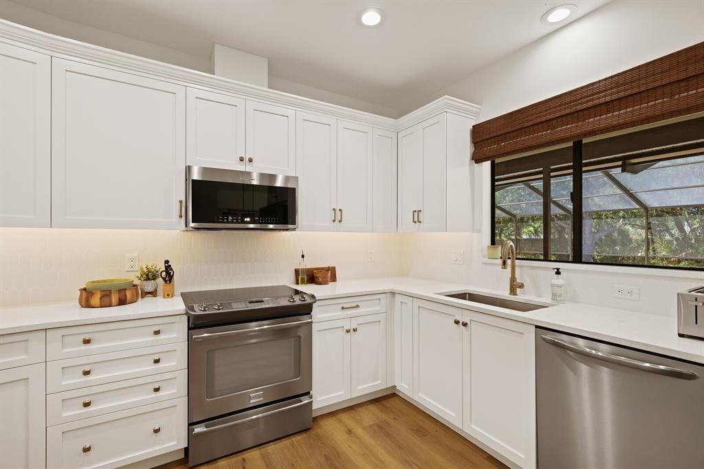 NEW quartz counters, appliances, cabinets, lighting in the kitchen