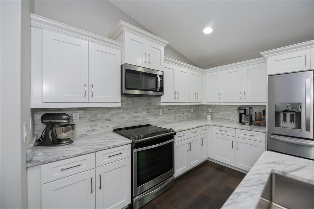 GORGEOUS KITCHEN has rich backsplash, stainless appliances