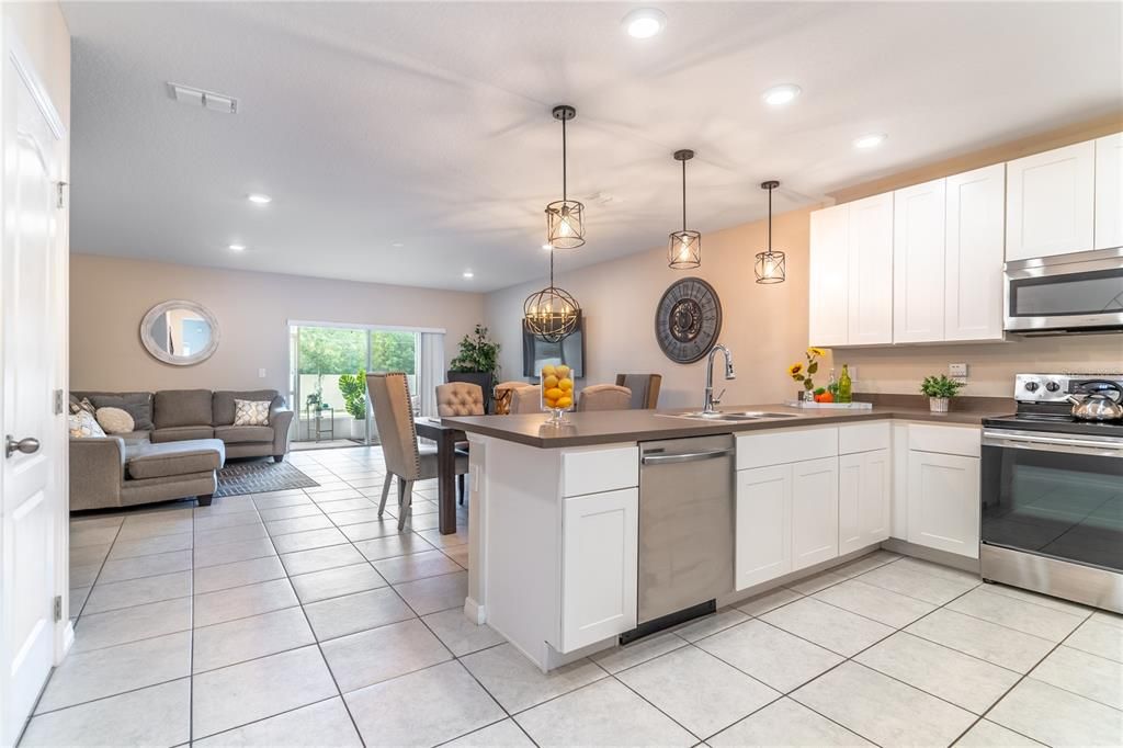 Kitchen features neutral floor tile