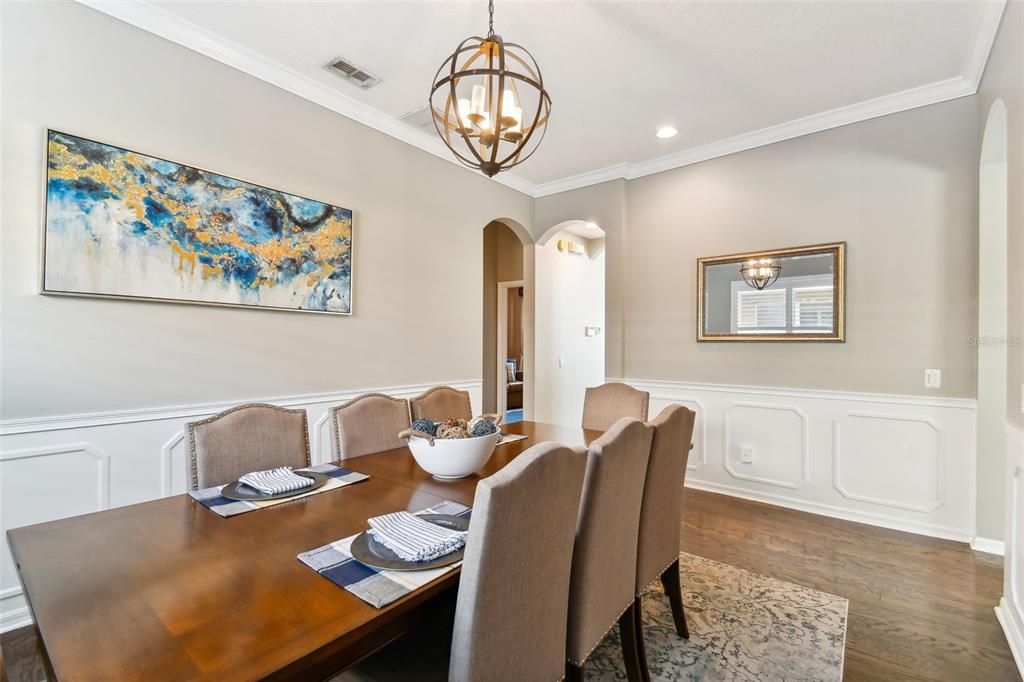 Another view of the formal dining room, highlighting the detailed wainscotting and crown moulding.