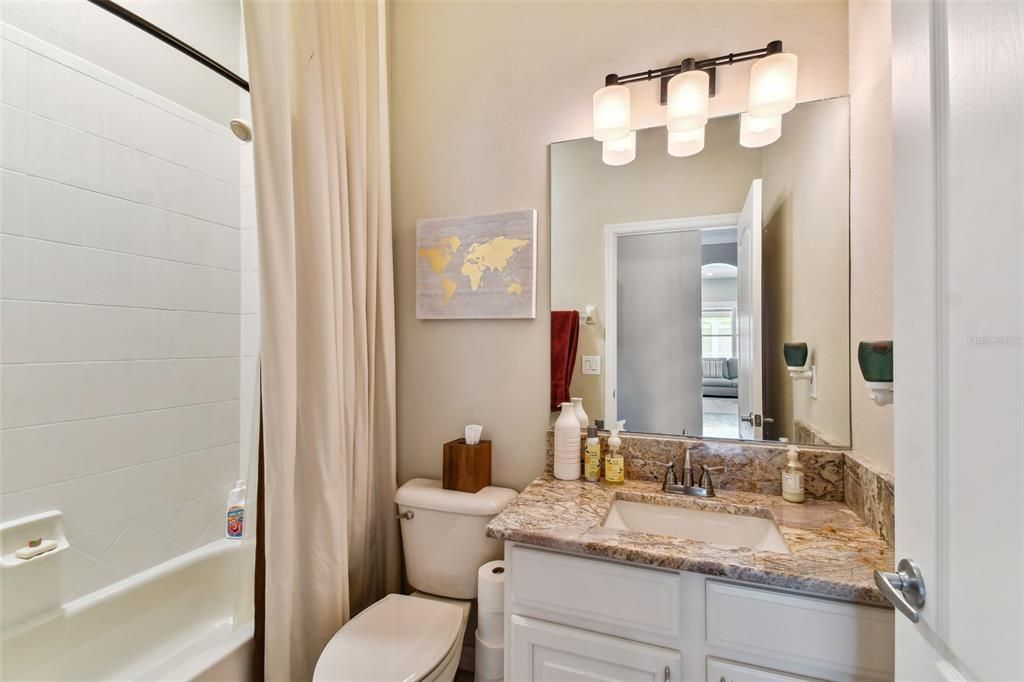 Downstairs guest bath with a gorgeous granite topped vanity.