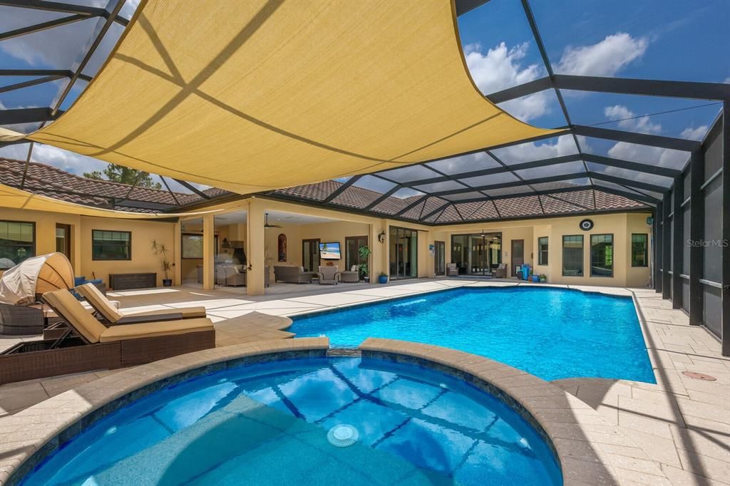 Relax and unwind on this immense 2700 sq ft lanai with Shellock pavers and sun shades