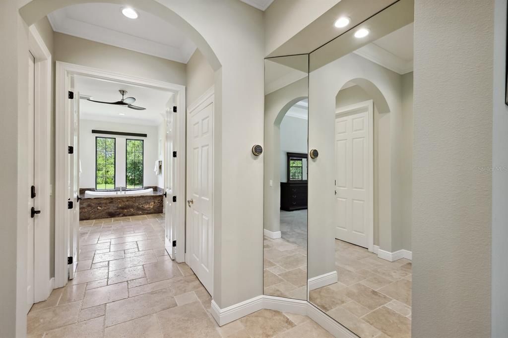 Master suite offering spacious double walk in closets. One closet is built as a safe or hurricane room comprising of cinder block walls and Browning Security/Vault door!