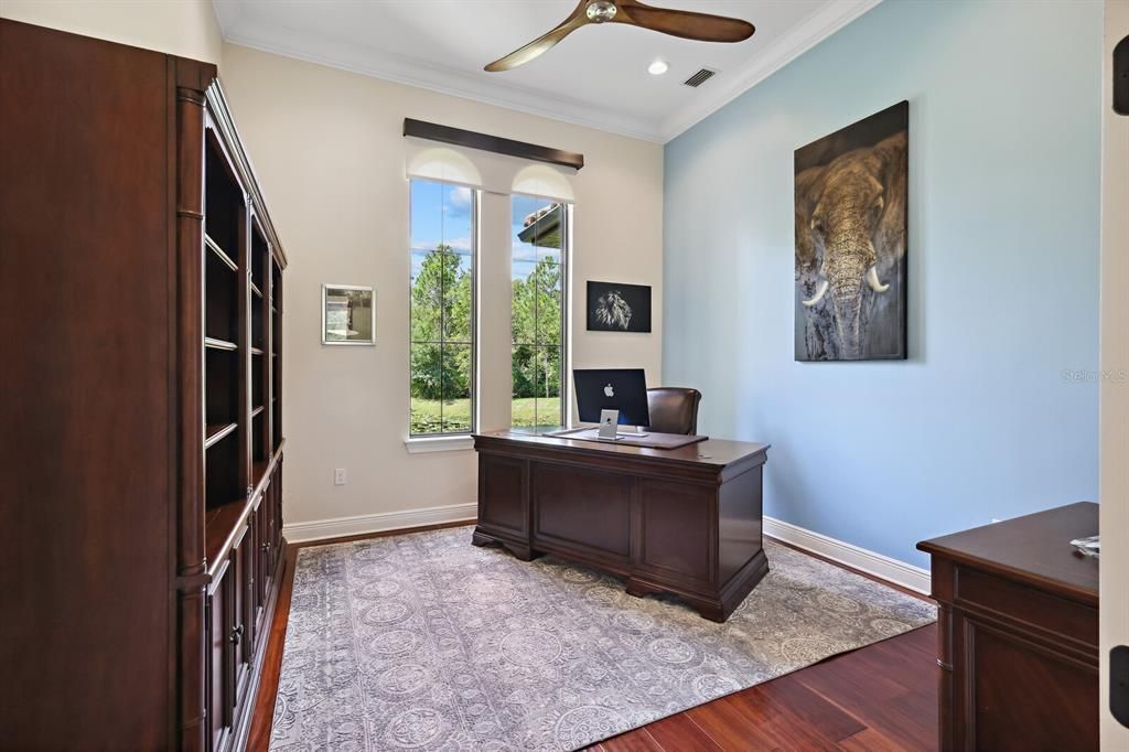 Executive office with gorgeous wood flooring and lots of natural light