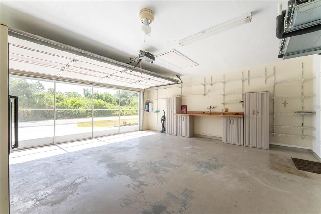 House garage has plenty of storage plus a screen to keep the bugs out!