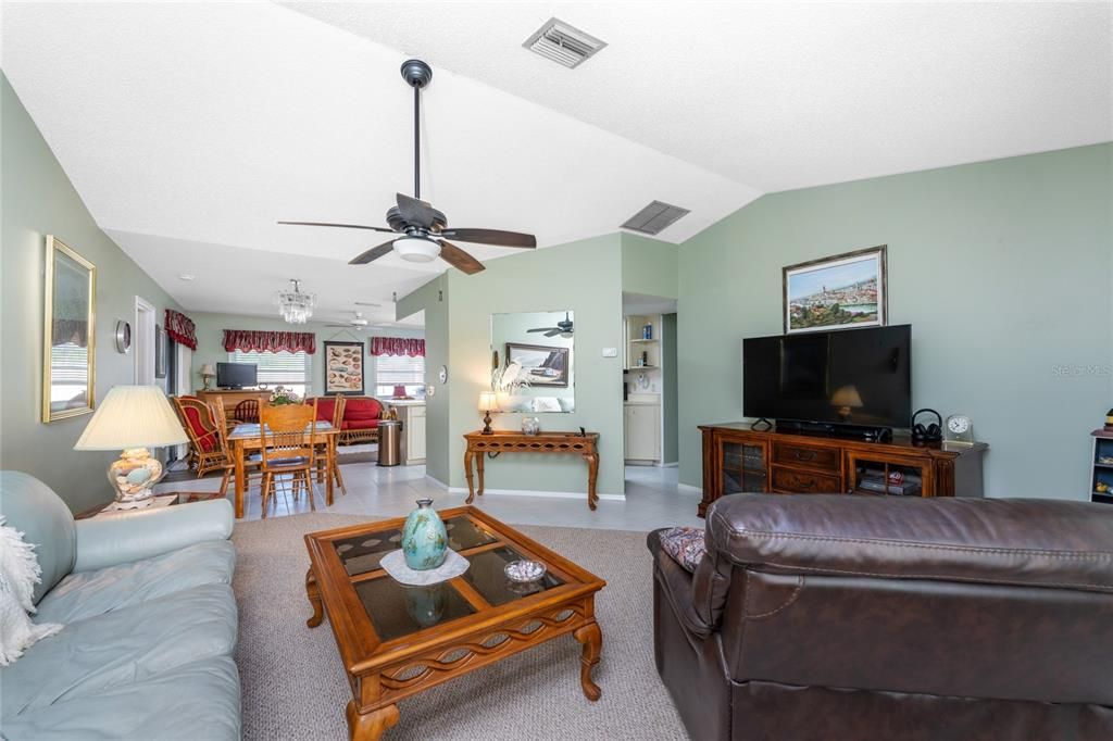 Living room view to dining area and kitchen.