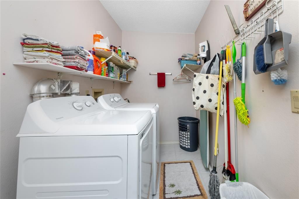 Laundry room has tiled flooring.