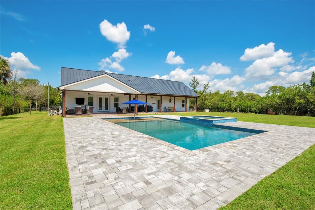 Heated 40 x 20 saltwater pool with 10' sunshelf and 10 x 10 spa and waterfall