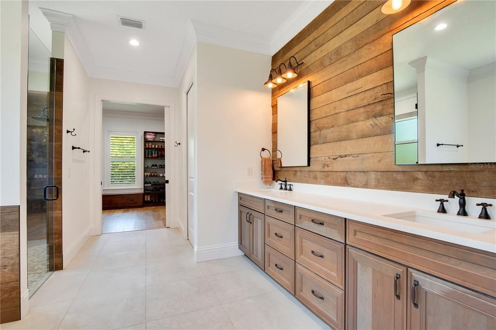 16' x 13' primary ensuite with a 9' quartz-topped vanity, dual sinks and custom shiplap wall