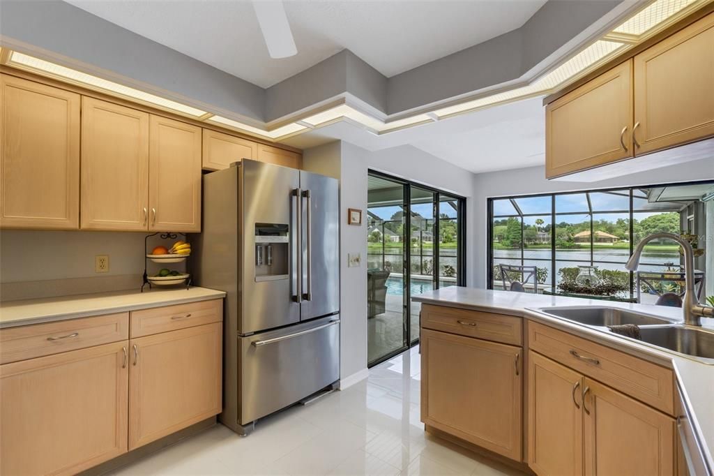 The kitchen...features Stainless appliances ( 2018) silestone countertops, solid wood cabinetry, Dual pantries, new floor tile and again ...an AMAZING  panoramic view of Lake Engle