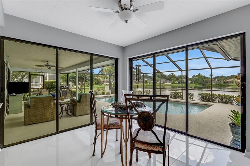 The eat-in dining area just off the kitchen and family room. These sliders open all the way , an invite the outdoors in, perfect for entertaining. Both sets of these sliders are dual direction sliders.