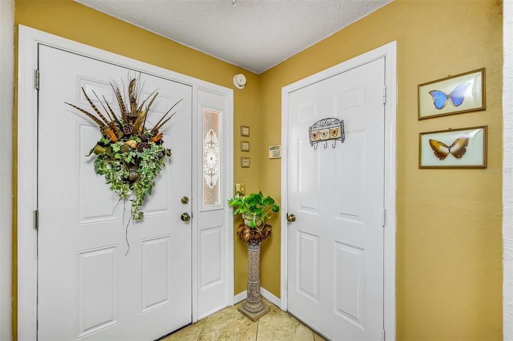 Front door, foyer and garage door access, coat closet across from front door.