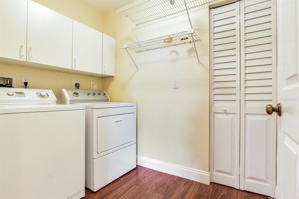 Separate laundry room with washer/dryer and cabinets and closet