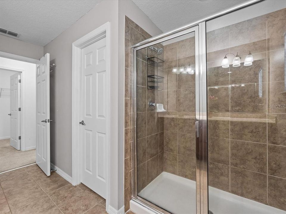 on the other end of upstairs, bedroom 2 with ceiling fan and ample closet space