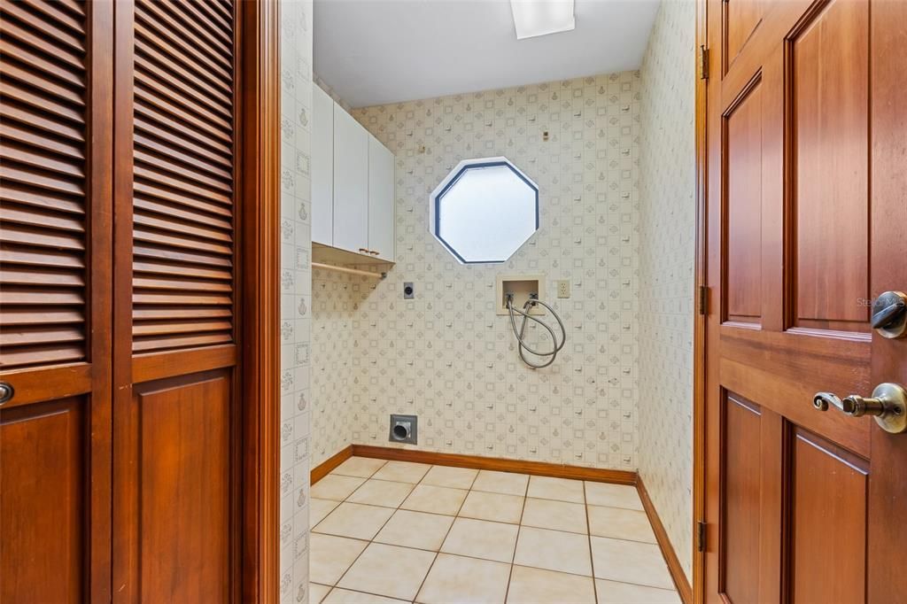 Laundry room with closet