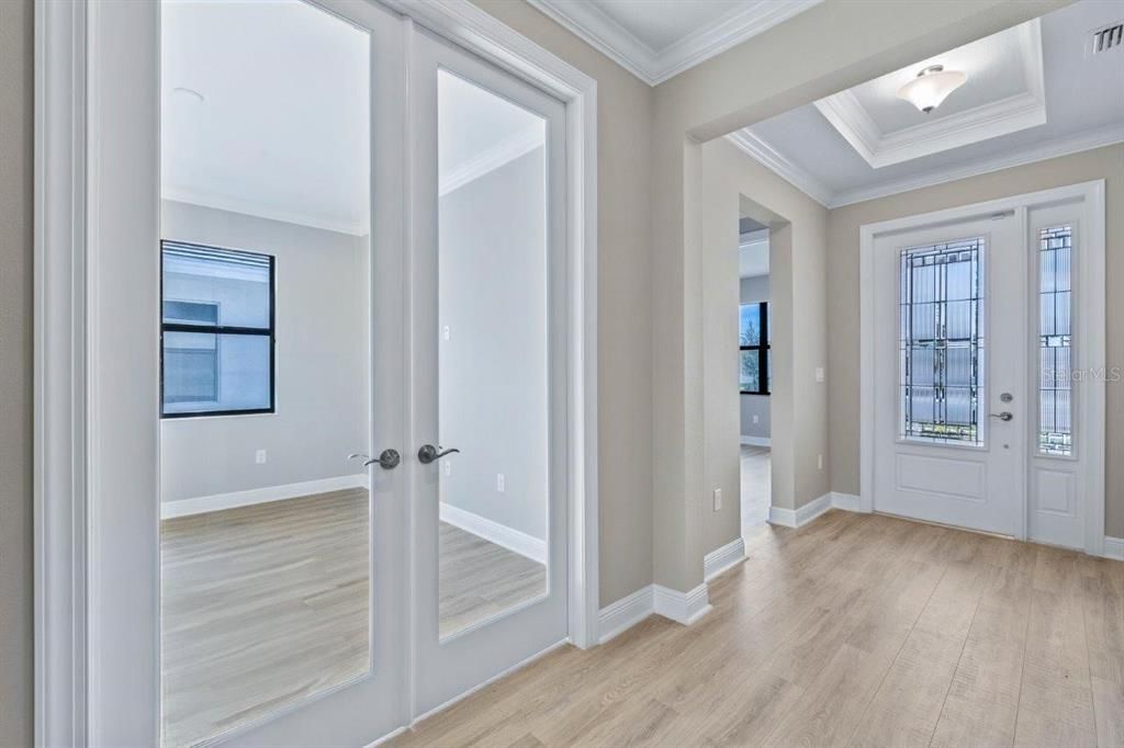 The den/bonus room featuring glass double doors, making this a perfect spot for a home office.