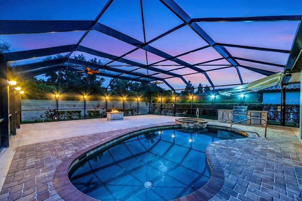 Solar Heated Pool and Spa with Ambient Night Time Lighting, Lighted Sun Shade over Outdoor Kitchen, Propane Gas Fire Pit on 40' x 40' Lanai