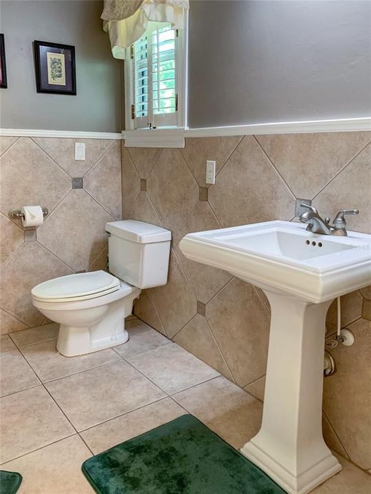 beautiful ceramic tile and pedestal sink.