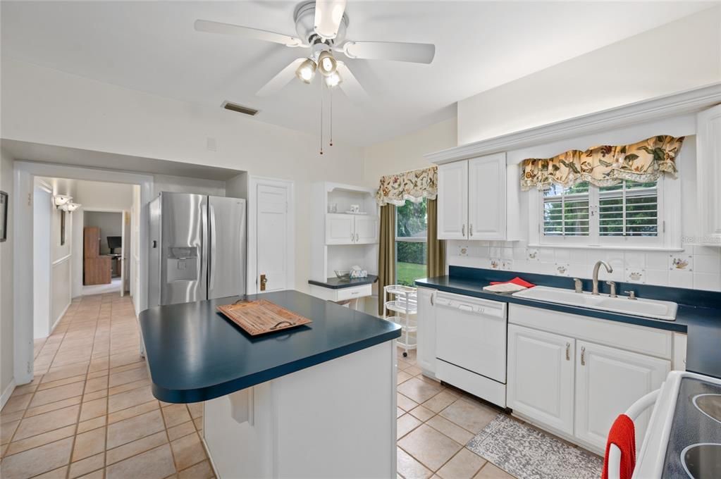 Beautiful kitchen with a newer stainless refrigerator, closet pantry and plenty of cabinets, even in the island.